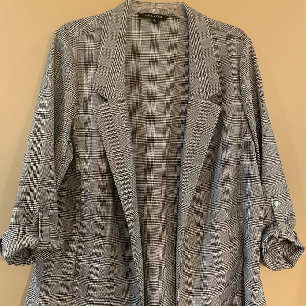 Classic plaid blazer with pockets and rolled up sleeves.